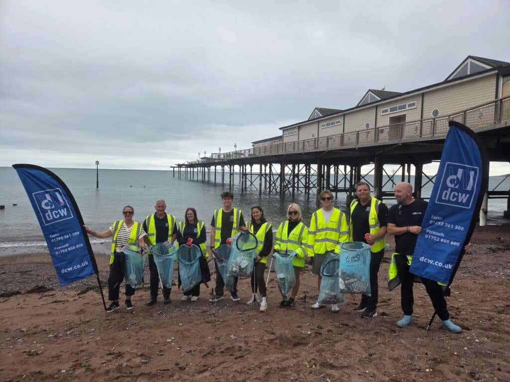 DCW team and volunteers with their filled up rubbish bags on Teignmouth Beach.